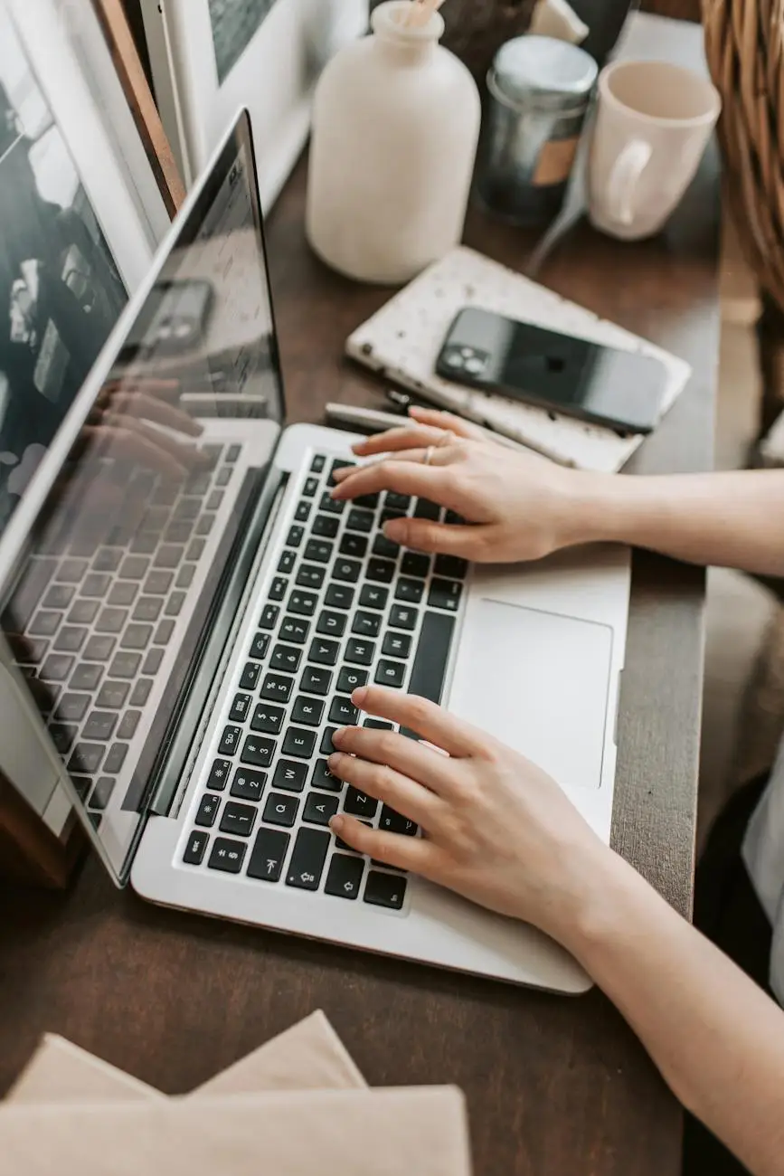 crop female freelancer using laptop at table at home