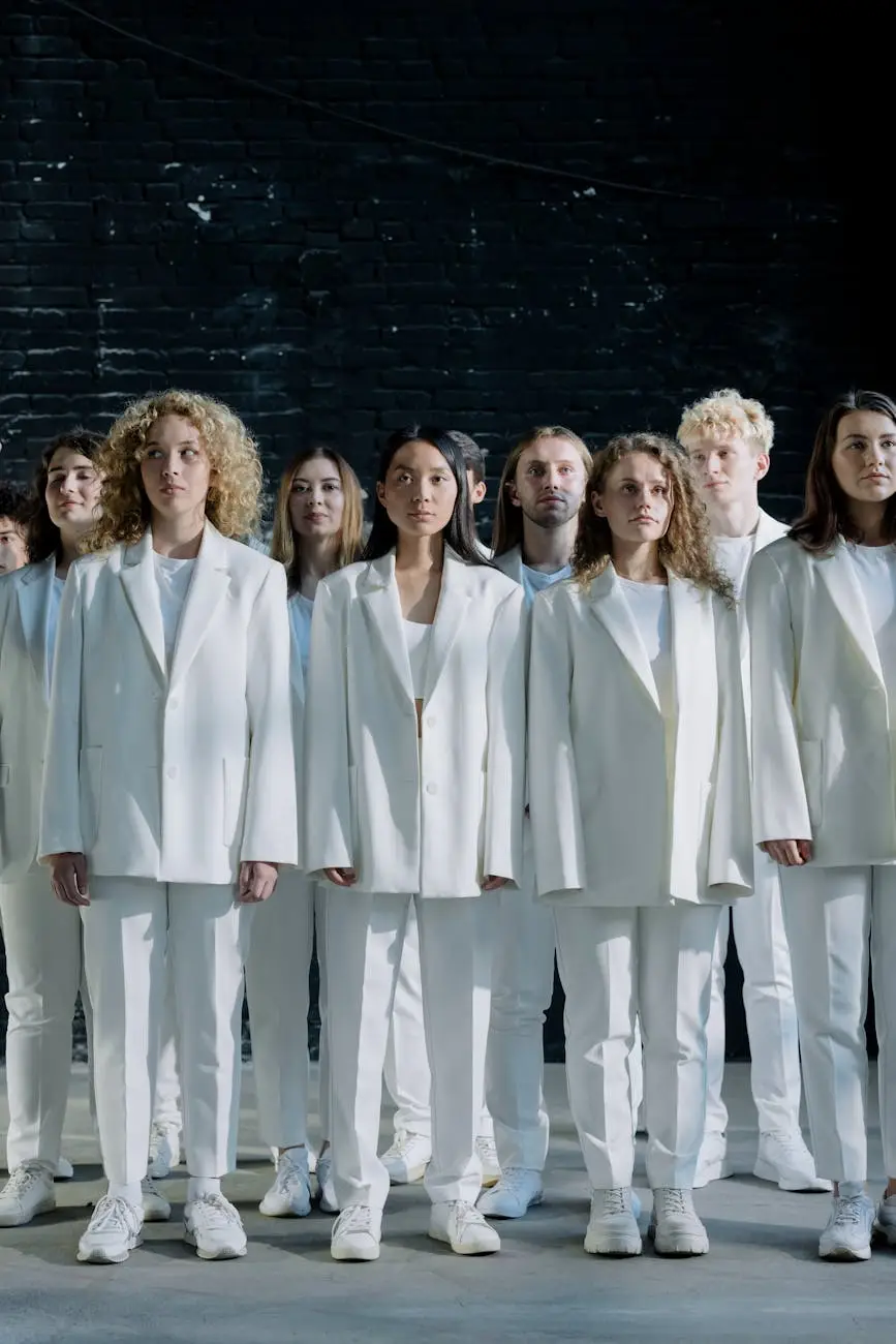 people in white suits standing near black wall